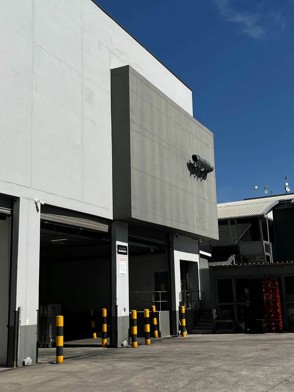 Open overhead doors at a commercial receiving yard