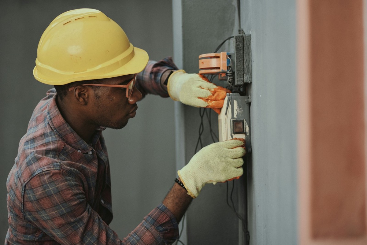 Technician working on an electrical control panel
